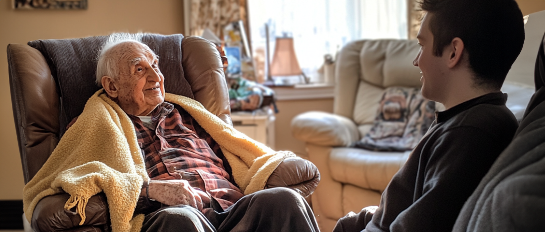 A grandfather who receives Special Monthly Compensation speaks with his grandson in his brightly lit living room.